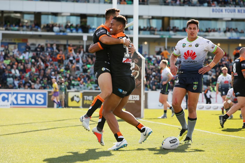 Michael Chee Kam celebrates his try against the Canberra Raiders with Luke Brooks.