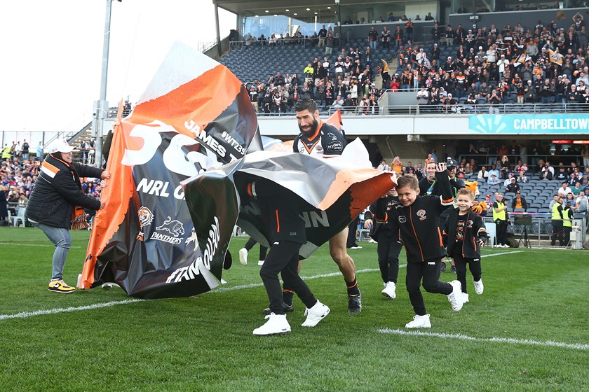 Jimmy and his boys bust through the banner celebrating 300 NRL games