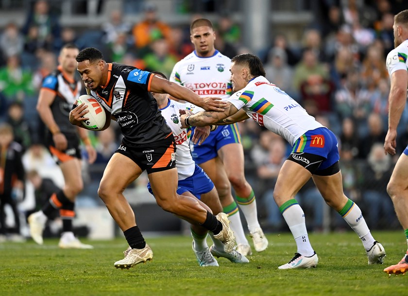 Sione Fainu bursts through the line on the way to scoring his first NRL try.